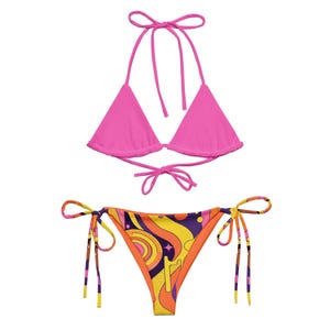 May include: A two-piece bikini set featuring a solid hot pink triangle top with adjustable halter and back ties. The matching bikini bottom has side ties and a vibrant, multi-colored retro-inspired wavy pattern in yellow, orange, purple, and pink.