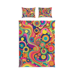 May include: A bedding set consisting of a rectangular duvet cover and two matching pillowcases, all featuring a vibrant, multi-coloured pattern of concentric circles, wavy lines, and star shapes in shades of pink, orange, yellow, blue, and green.