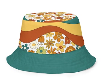May include: A teal bucket hat with a retro floral pattern. The hat features a wavy design in yellow, orange, and brown, with a white band adorned with various flower designs. The brim is a solid teal color.