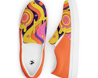 May include: A pair of slip-on trainers featuring a vibrant graphic pattern of yellow, orange, purple, and pink wavy lines, circles, and dripping shapes. The shoes have solid orange side panels, white rubber soles, and a small logo inside the heel.