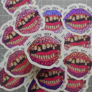 May include: Multiple pink and purple glitter stickers with a cartoon image of a mouth with teeth falling out. The text on the stickers reads "My Teeth Keep Falling Out".