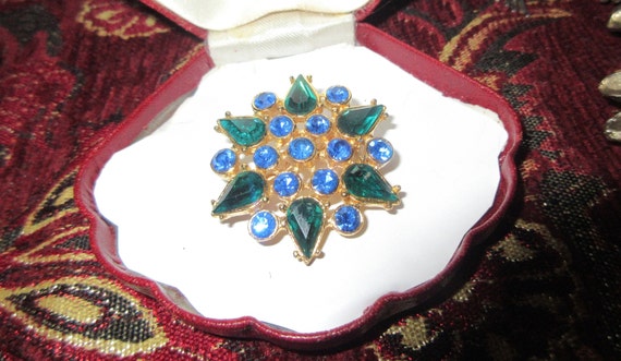 Lovely vintage gold plated green and blue rhinestone starburst brooch