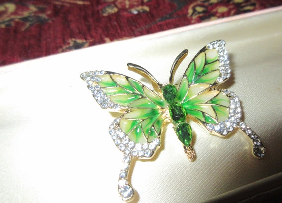 Charming goldtone green and clear rhinestone glass butterfly brooch