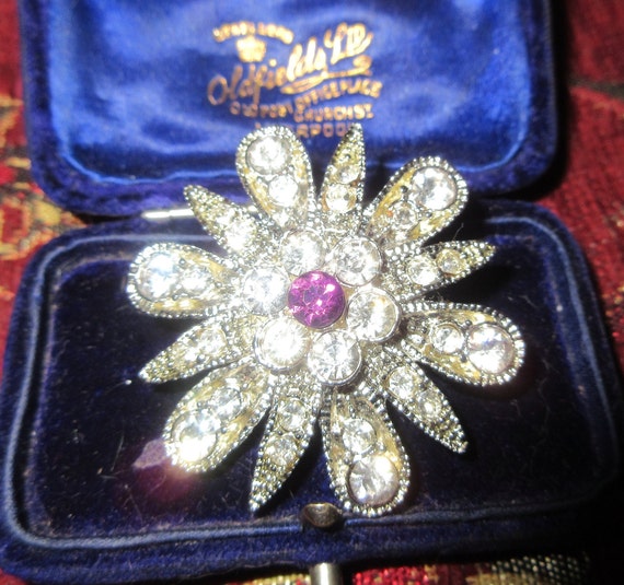 Lovely vintage silverplated flower star brooch with clear and purple rhinestones