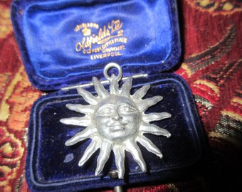 Wonderful vintage matt silver hammered sun face pendant