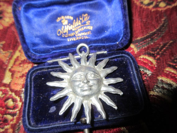 Wonderful vintage matt silver hammered sun face pendant