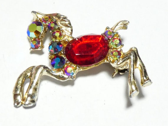 Lovely vintage goldtone red rhinestone and aurora glass horse   brooch