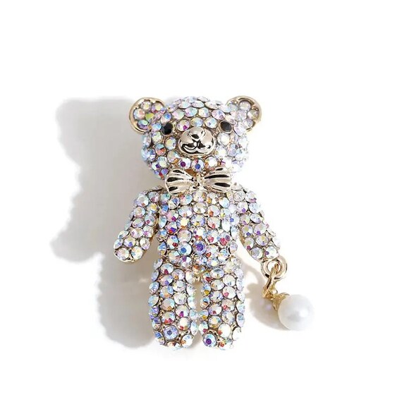 Cute sparkly aurora borealis teddy holding a ball brooch