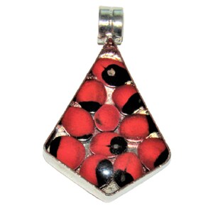 May include: A silver pendant with a triangular design, containing red and black seeds. The pendant has a silver bail for a chain. The seeds are bright red with a black marking. The pendant is a unique piece of jewellery.