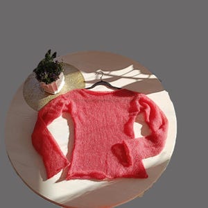 May include: A set of three ceramic mugs with a speckled, matte finish. The mugs are in cream, light grey, and dark grey. Each mug has a simple, minimalist design, ideal for coffee or tea.