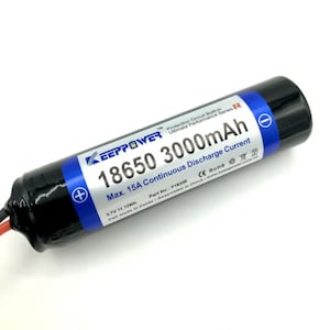May include: A black 18650 rechargeable battery with a white label that reads "KEEPPOWER TM Protection Circuit Built-in Ultimate Performance Series-R 18650 3000mAh Max. 15A Continuous Discharge Current 3.7V 11.10Wh Part No.: P1830R CE ROHS Cell made in Korea Assembled in China www.keepower.com.cn".