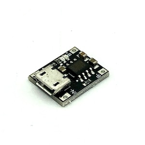 May include: A small black circuit board with a micro USB connector, labeled with "B+", "B-", "IN+", and "IN-".