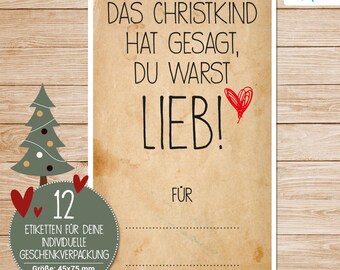 May include: A brown and white gift tag with the text "Das Christkind hat gesagt, du warst lieb!" and a red heart. The tag has a space to write "FÜR" and a line for a name. The tag is 45 mm by 75 mm.