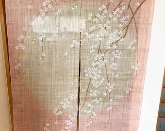 May include: A pair of pink and beige Japanese room dividers with a white cherry blossom design. The dividers are made of a woven fabric and have a subtle gradient from beige to pink.