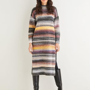 May include: A long, striped sweater dress in shades of gray, brown, yellow, and purple. The dress has a high neckline, long sleeves, and a slit on each side. The person is wearing black knee-high boots.