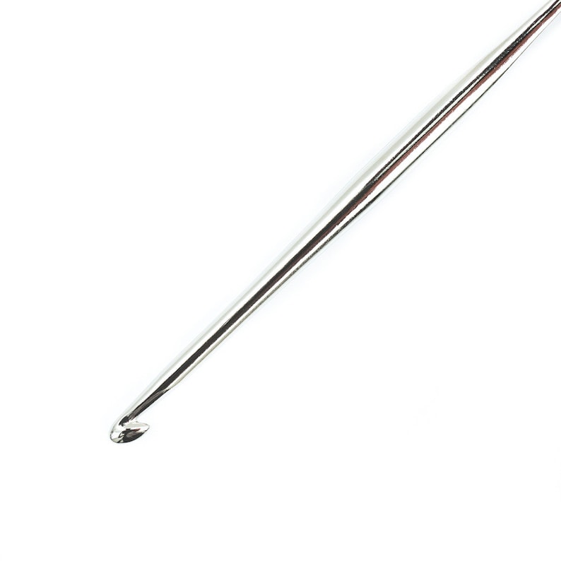 May include: A silver crochet hook with a pointed tip and a smooth, shiny finish.