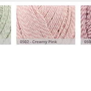 May include: A collection of yarn skeins in various colors, including creamy blue, creamy green, creamy pink, spotty pink, spotty blue, and spotty green. The yarn is arranged in a row, with each skein labeled with its color and number.