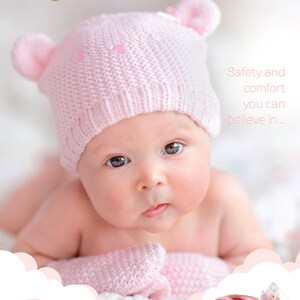 May include: A pink knitted baby hat with bear ears and a ball of pink yarn. The text "Anchor Baby Pure Cotton" is visible in the top left corner of the image. The text "Safety and comfort you can believe in..." is visible in the top right corner of the image.