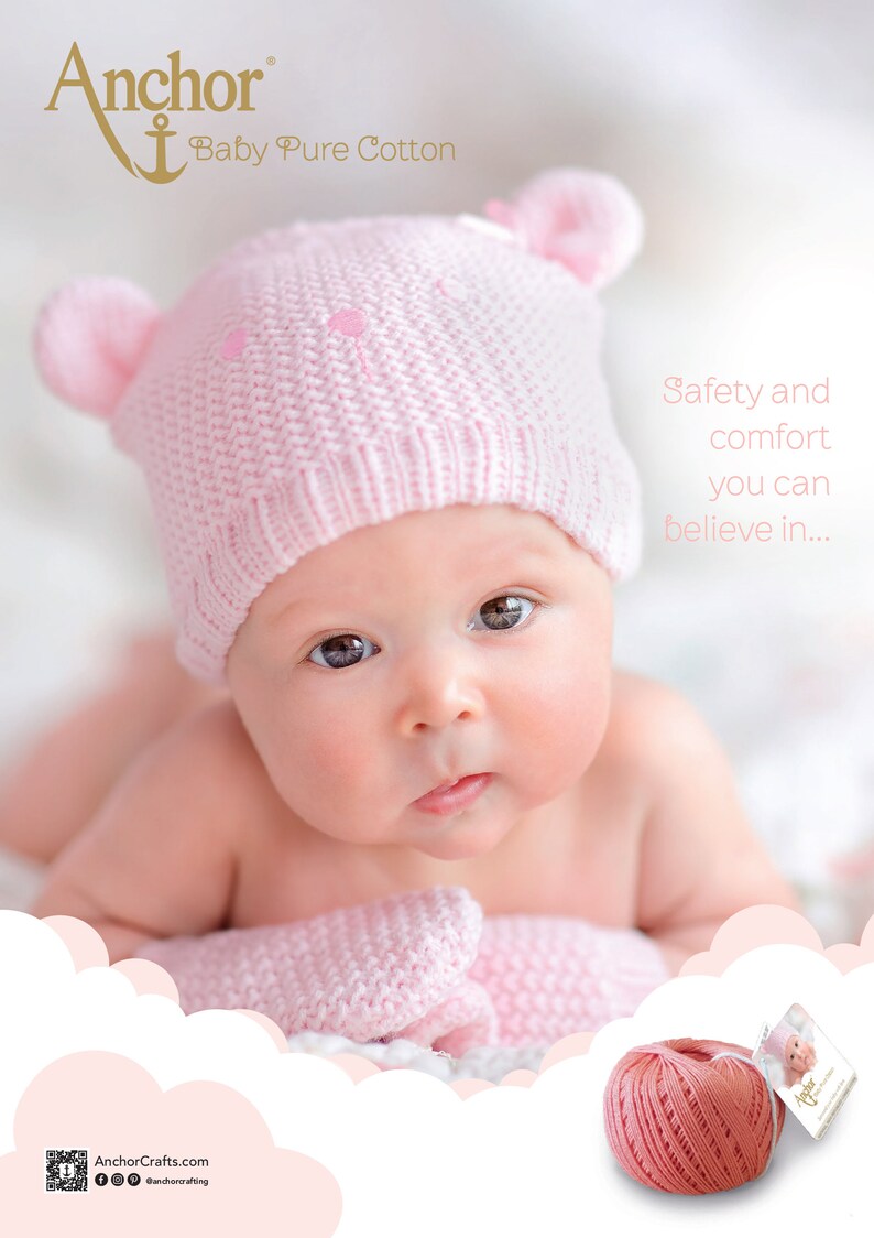 May include: A pink knitted baby hat with bear ears and a ball of pink yarn. The text "Anchor Baby Pure Cotton" is visible in the top left corner of the image. The text "Safety and comfort you can believe in..." is visible in the top right corner of the image.
