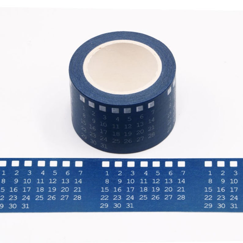 May include: A roll of blue washi tape with white numbers 1 through 31 printed on it. The tape is designed to look like a film strip.