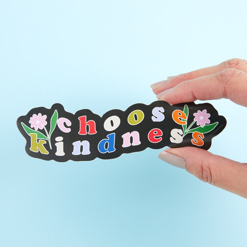 May include: Black sticker with the words "choose kindness" in colorful letters, with a flower design on each side.
