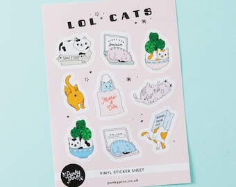 May include: A pink sheet of vinyl stickers featuring various illustrations of cats with humorous captions. The stickers include cats in a spaceship, fighting for feminism, hiding from life, and being a mother of cats. The sheet is titled "LOL CATS" and includes the website punkypins.co.uk.