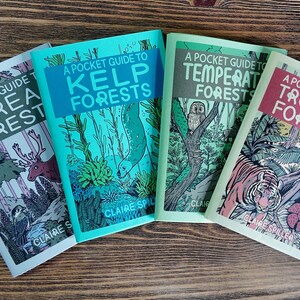 May include: Four softcover books titled A Pocket Guide to Boreal Forests, Kelp Forests, Temperate Forests, and Tropical Forests by Claire Spiller. Each book features a distinct color palette and detailed illustrations of animals and plants.