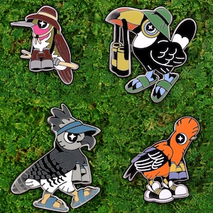 May include: Four colorful bird-themed enamel pins. The pins feature a hummingbird with a brown hat and binoculars, a toucan with a green hat and carrying a container, a gray bird with a blue visor, and an orange bird with a black and white wing.