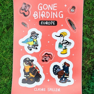 Könnte beinhalten: Ein rotes Stickerbogen mit dem Text "GONE BIRDING EUROPE" und Illustrationen von Cartoon-Vögeln mit Hüten und Ferngläsern. Der Name des Künstlers, Claire Spiller, ist unten aufgedruckt.