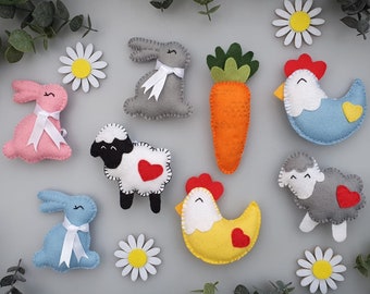 May include: A set of felt animal and food ornaments, including a bunny, a sheep, a chicken, a carrot, and a bird. The ornaments are all in different colors and have embroidered details.
