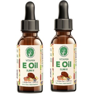 May include: Two brown glass bottles of Vitamin E Oil with black droppers. Each bottle has a label with the text "Mother Nature's Essentials Vitamin E Oil 21,000 IU". The label also includes images of nuts and berries.