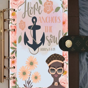 May include: A light blue planner page with a floral design. The page features a quote that reads "Hope anchors the soul" with an anchor graphic and the scripture reference "Hebrews 6:19". The page also features a cartoon illustration of a person wearing sunglasses and a hat.