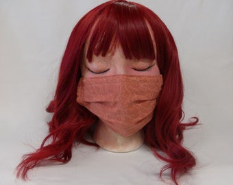 Handmade 100% cotton double layer pleated orange marble print face mask with nose wire, elastic ear loops, and filter pocket.