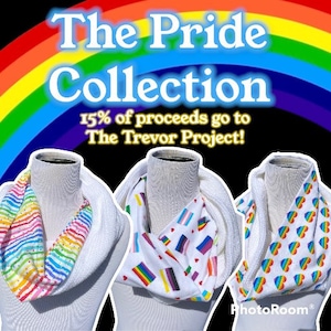 May include: Three white infinity scarves with different pride flag patterns. The scarves are on mannequins. The text "The Pride Collection" and "15% of proceeds go to The Trevor Project!" is displayed above the scarves.