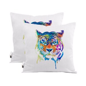 May include: Two white throw pillows with a colorful watercolor tiger face design. The tiger's eyes are blue, and the rest of the face is a mix of orange, yellow, green, and purple.