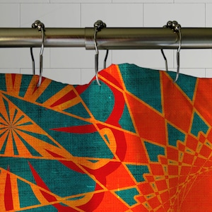 May include: A shower curtain with a geometric pattern in shades of orange, red, and teal. The pattern is made up of overlapping triangles and circles.