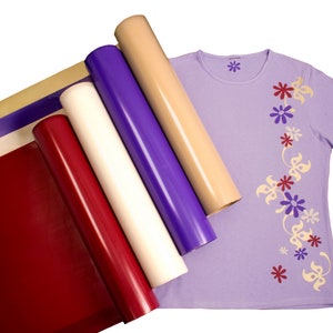 May include: Five rolls of heat transfer vinyl in various colors, including red, white, purple, and beige, with a purple t-shirt featuring a floral design in beige and purple.
