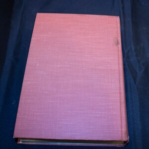 May include: A pink hardcover book with a textured linen cover.
