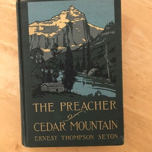 May include: The Preacher of Cedar Mountain by Ernest Thompson Seton, a vintage book cover with a mountain scene in blue, green, and gold.