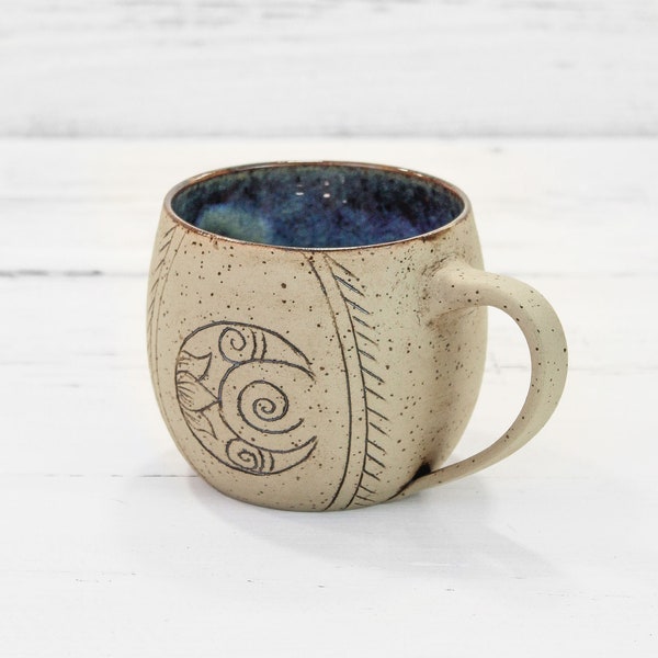 Handmade pottery stoneware ceramic coffee or tea cup with moon hand carved on the side. Artisan handcrafted, wheel thrown farmhouse mug