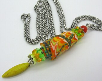 A long stainless steel chain with large handmade lampwork bead in yellow orange, unique piece