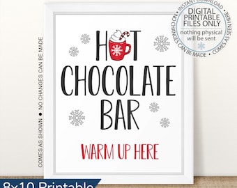 May include: Printable sign for a hot chocolate bar. The sign is white with red and black text. It says "Hot Chocolate Bar" with a red mug of hot chocolate and a snowflake design. The text "Warm Up Here" is in red at the bottom.
