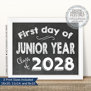 May include: A framed chalkboard-style print with white text that reads "First day of Junior Year Class of 2028." The print is in a white frame and includes the text "Instant Download Digital Printable Files Only."