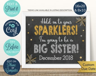 May include: A chalkboard-style sign with a white frame. The sign reads "Hold on to your SPARKLERS! I'm going to be a BIG SISTER! December 2018." Gold and silver text with star and firework accents. Includes text: "Edit & Print it Today!"