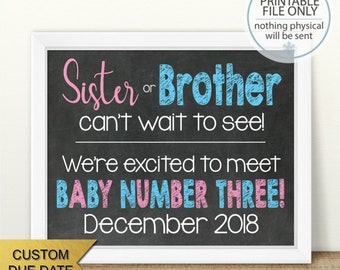 May include: A chalkboard sign with a white frame announcing the arrival of a new baby. The sign reads "Sister or Brother can't wait to see! We're excited to meet Baby Number Three! December 2018".