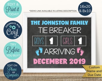 May include: A black chalkboard style sign with white text announcing a baby's arrival. The sign reads "The Johnston Family Tie Breaker Boys 1 Girls 1 Arriving December 2019". The sign is framed in a white frame and has blue and pink footprints on either side of the text "Arriving".
