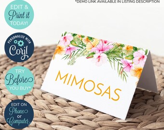 May include: A white printable table card with a floral border featuring pink and yellow hibiscus flowers and green leaves. The text "MIMOSAS" is printed in gold letters.