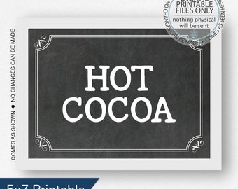 May include: Printable sign with a chalkboard background and white text that reads "HOT COCOA". The sign is framed with a white border and has a decorative flourish in each corner.