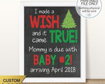 May include: A chalkboard style Christmas pregnancy announcement with a green and red Christmas tree and the text "I made a wish and it came true! Mommy is due with Baby #2! arriving April 2018"