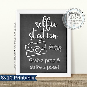 May include: A printable 8x10 inch sign with a chalkboard background. The sign says "selfie station" in white text with a white camera graphic and the text "OH SNAP! Grab a prop & strike a pose!"